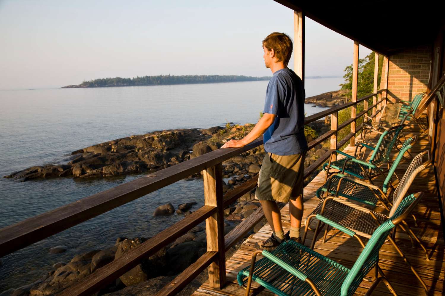 Man looking over water from Rock Harbor Lodge deck in Isle Royale National Park
