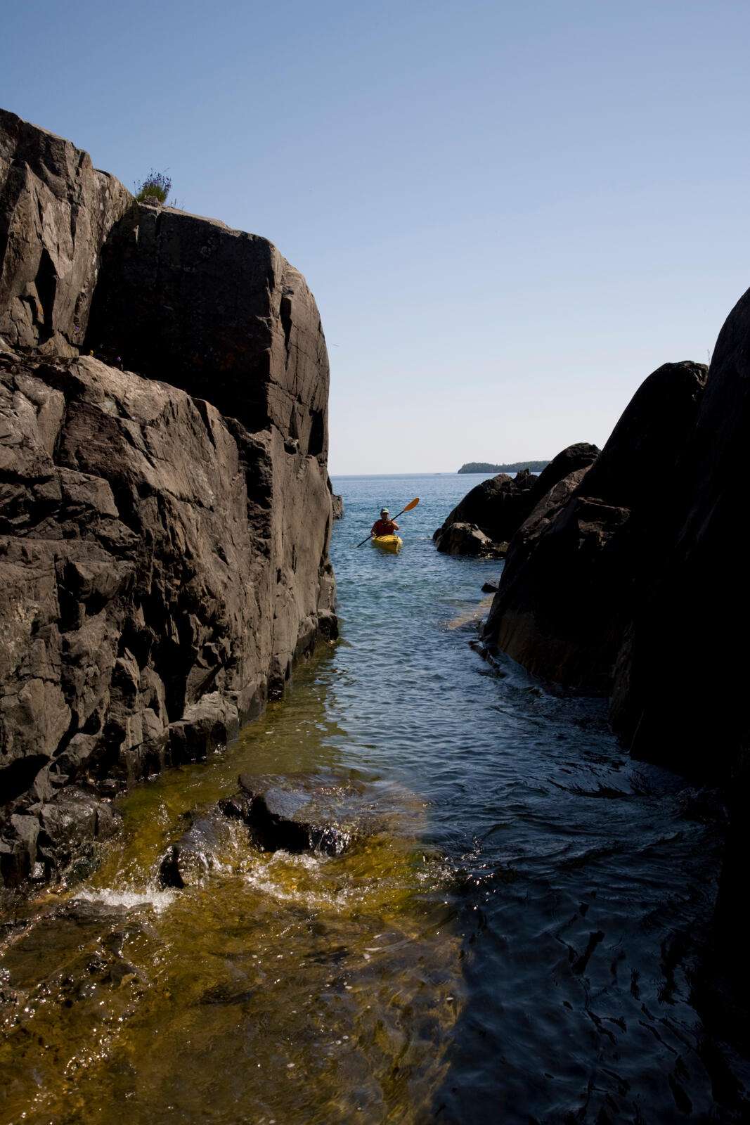Kayaking between rocks in Isle Royale National Park