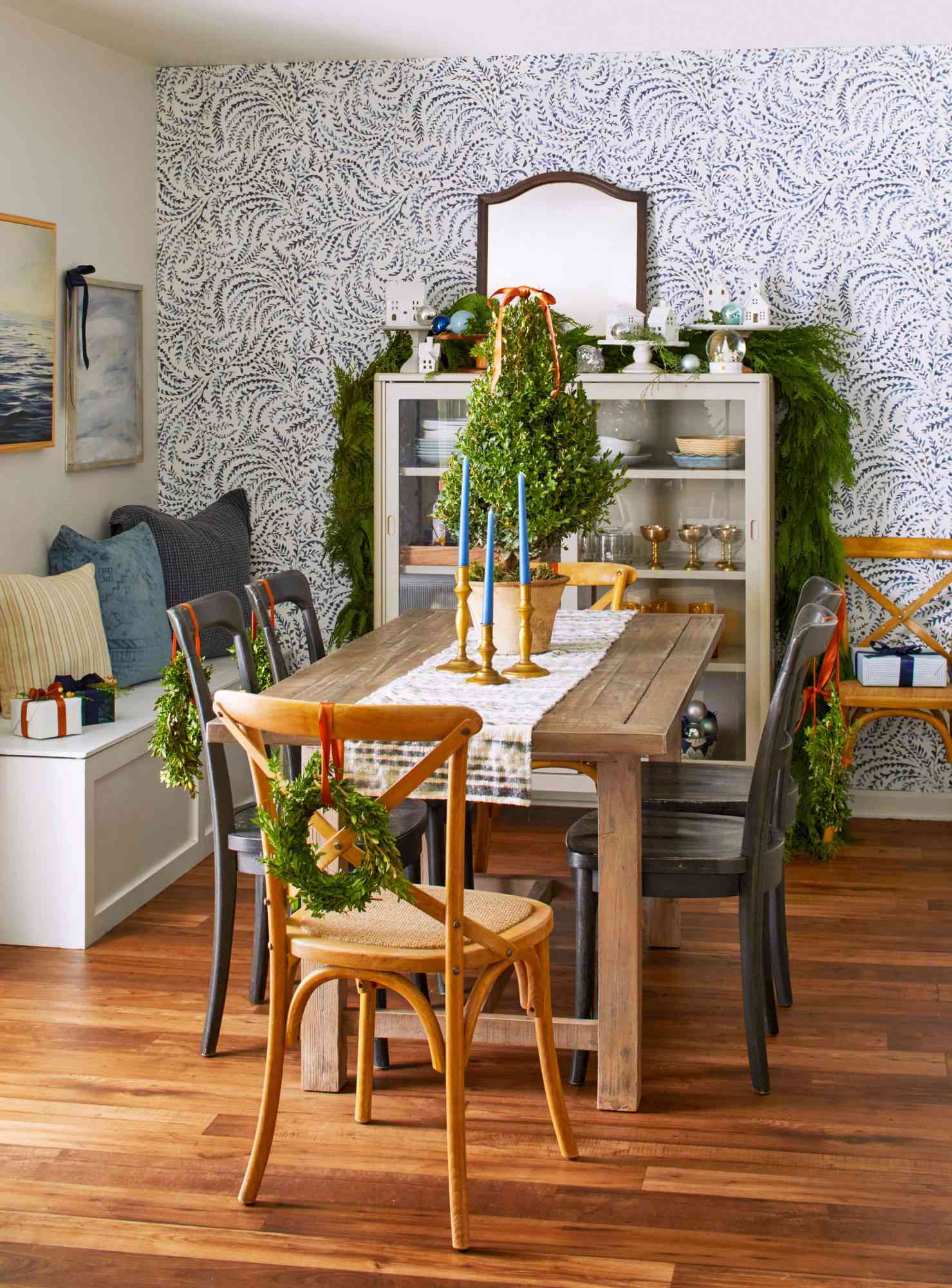 Dining room decorated with greenery and other holiday trim