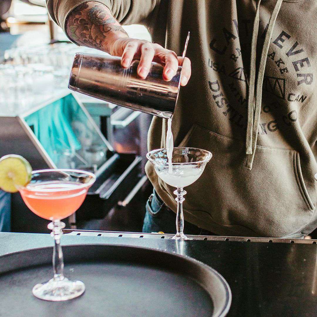 bartender pouring a cocktail