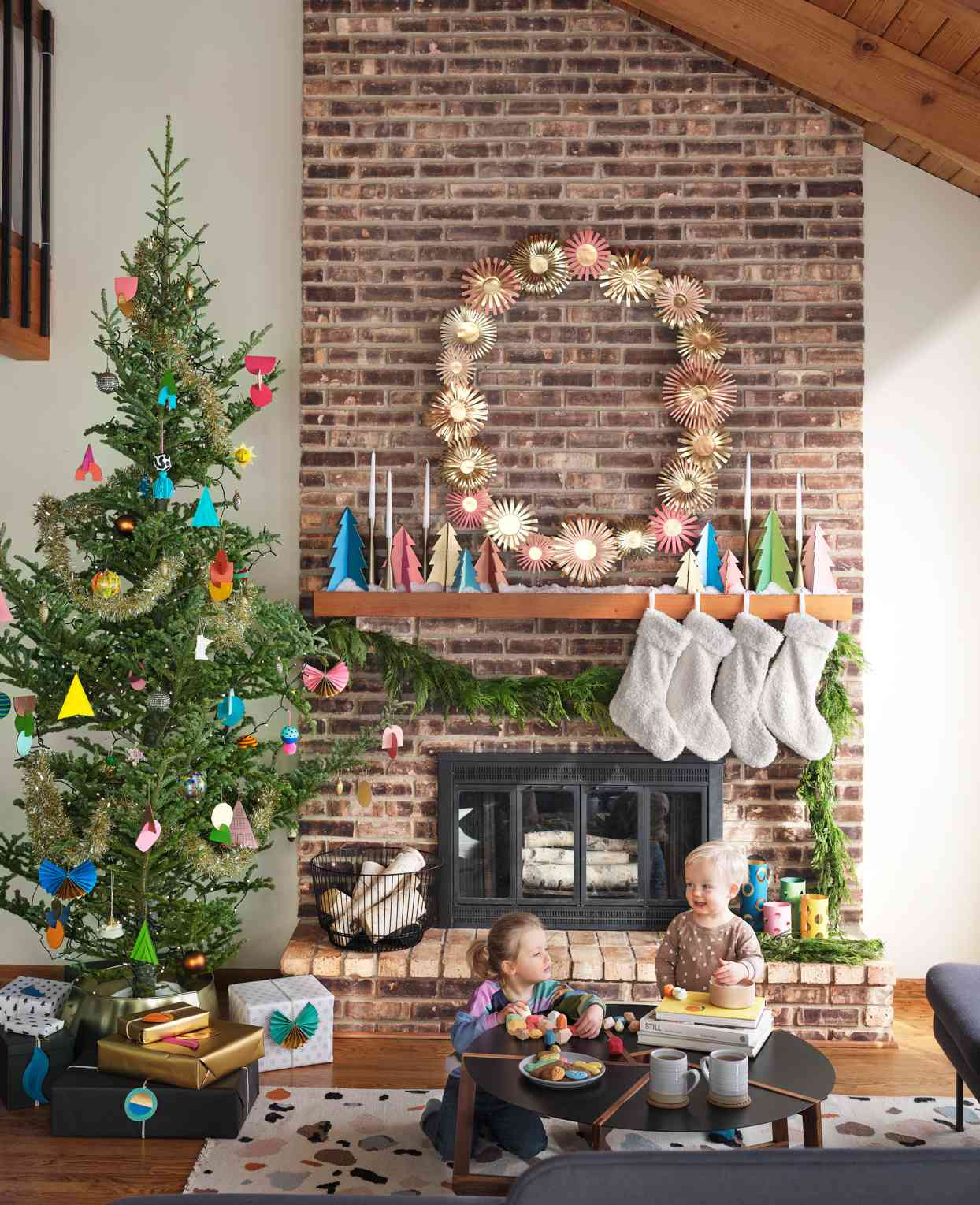 children playing near fireplace and christmas tree