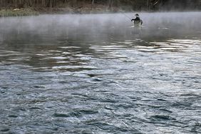 Person fishing in water of Montauk State Park, Missouri
