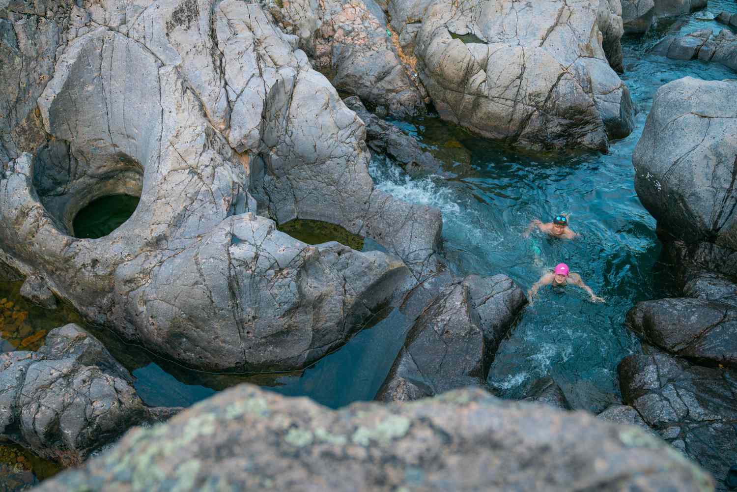 Swimmers among big rocks at Johnson's Shut-Ins State Park in Missouri