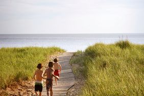 kids running towards beach