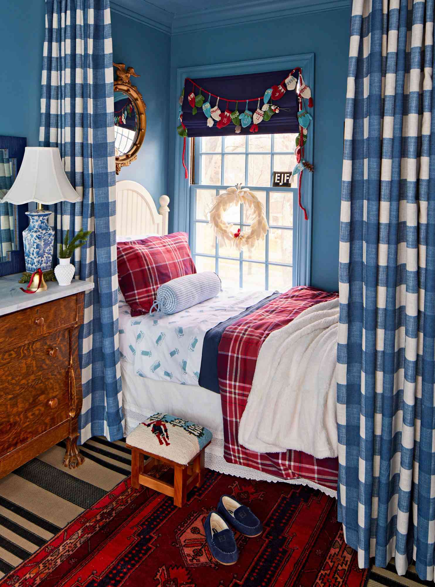 Garlands and blue plaid curtains surround a bedroom