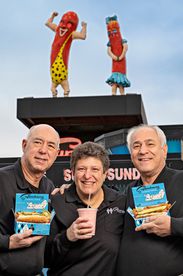 people standing in front of Superdawg