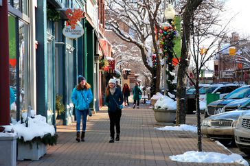 people walking through festively decorated downtown holland