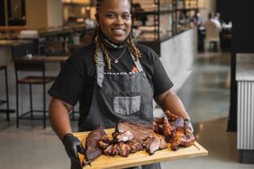 Dominique Leach holding tray of BBQ meat at Lexington Betty