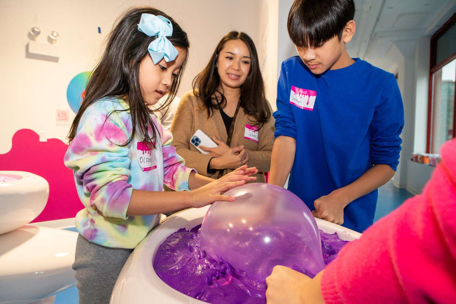 Kids playing with slime at Sloomoo Institute