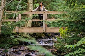 woman bridge forest stream pictured rocks national lakeshore michigan upper peninsula
